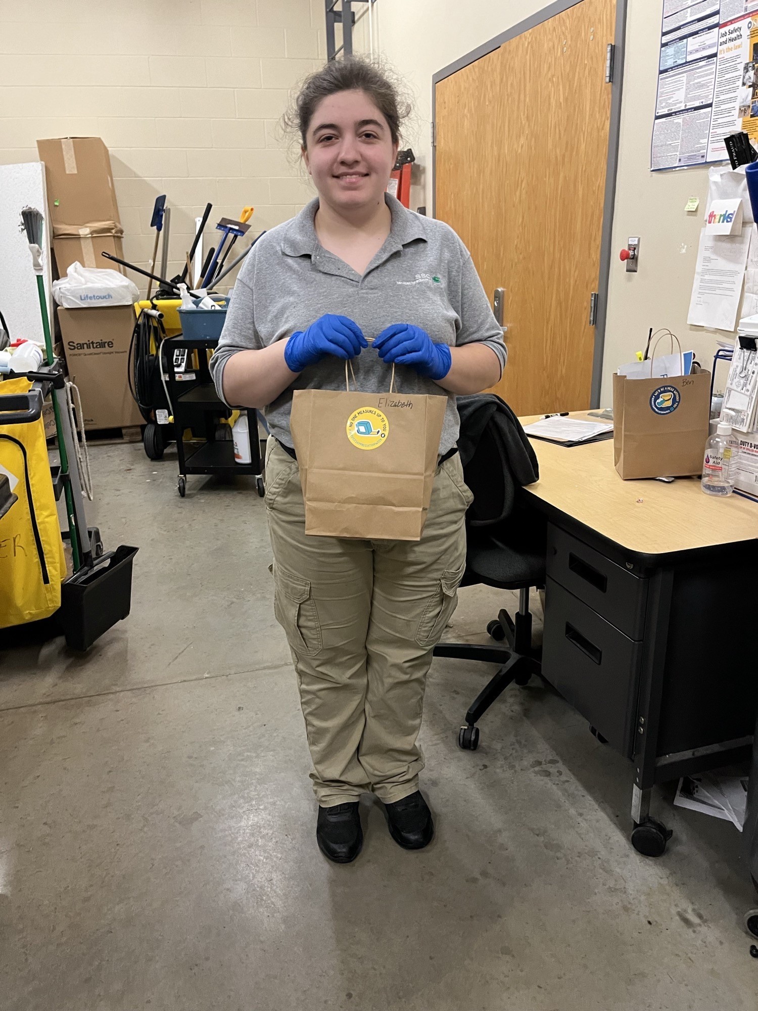 A photo of a Bentonville SSC associate holding a gift bag