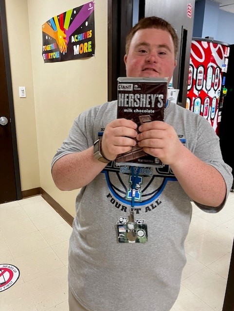 A photo of a student at Texas A&M University Corpus Christi holding up a candy bar prize